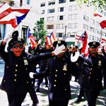 Puerto Rican members of the NYPD greeting revelers.